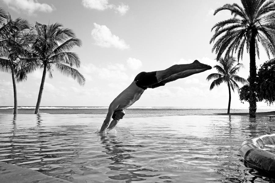 Man diving into swimming pool ()